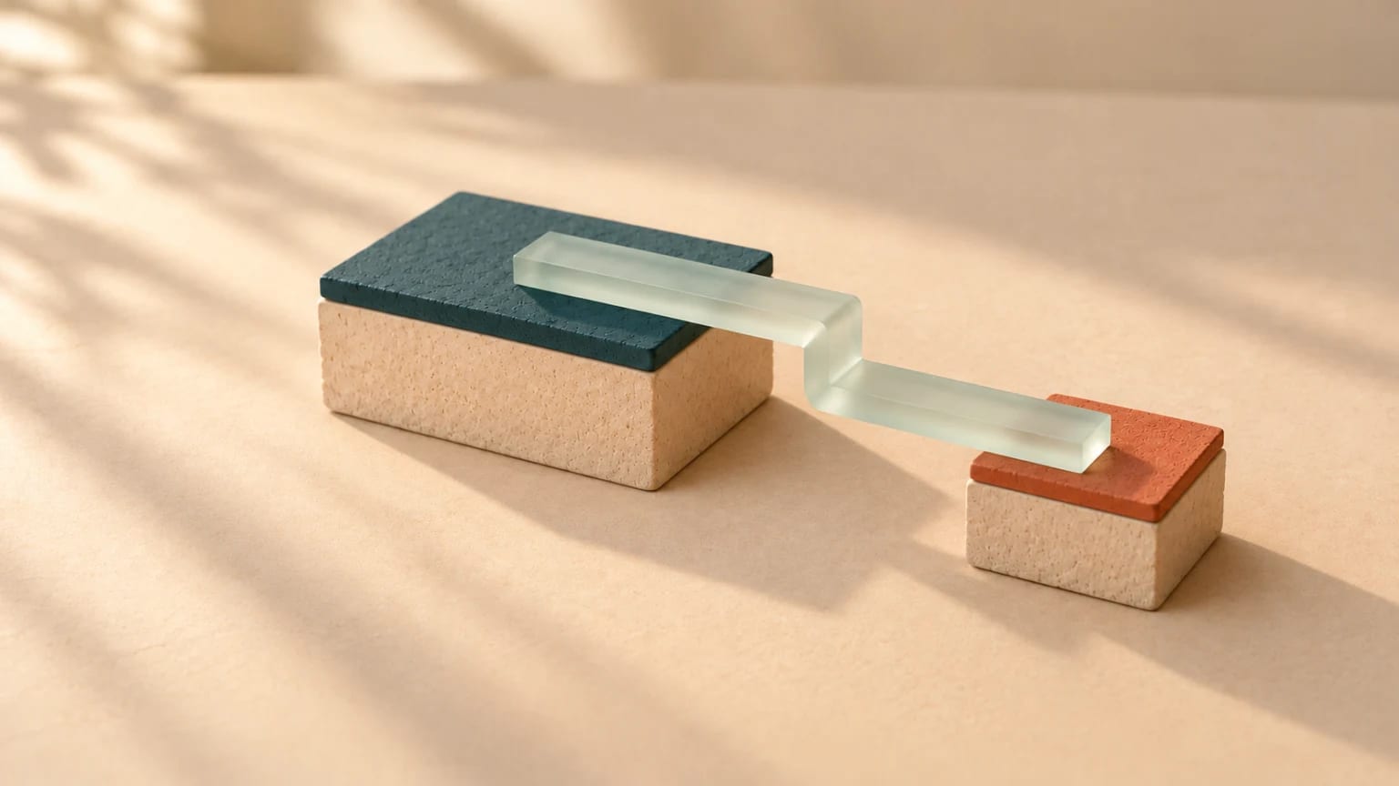 A frosted glass ribbon leaves a large teal-capped clay block, steps sideways in mid-air, and lands instead on a smaller separate block capped in coral.